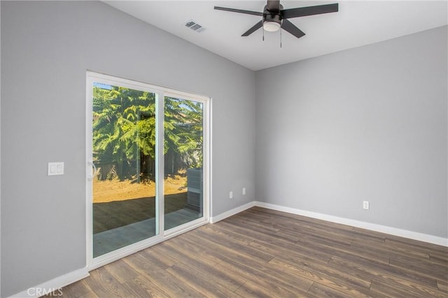 spare room featuring ceiling fan and dark wood-type flooring