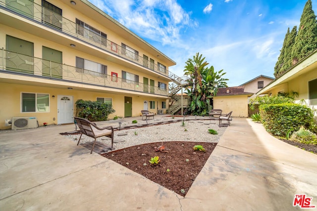 view of community with ac unit and a patio