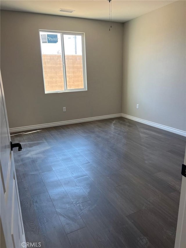 unfurnished room featuring dark hardwood / wood-style flooring