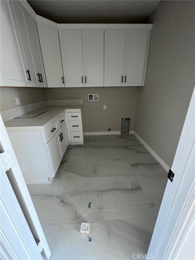 washroom with gas dryer hookup, cabinets, and washer hookup