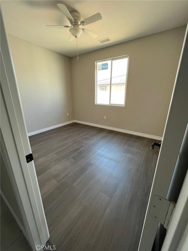 unfurnished room featuring dark hardwood / wood-style flooring and ceiling fan