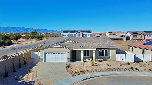 ranch-style house featuring a garage and a mountain view