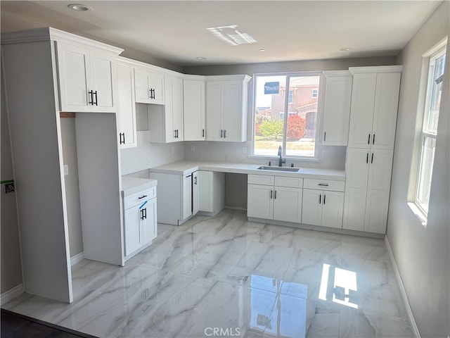 kitchen featuring sink and white cabinets