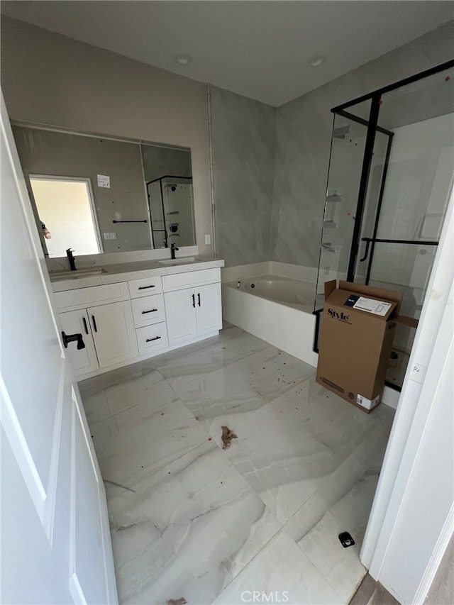 bathroom with a tub and vanity