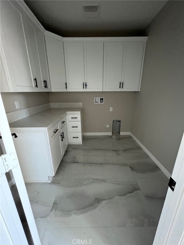 washroom featuring washer hookup and cabinets