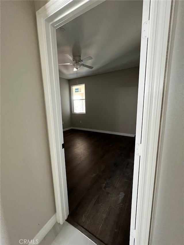 spare room featuring ceiling fan and dark hardwood / wood-style flooring