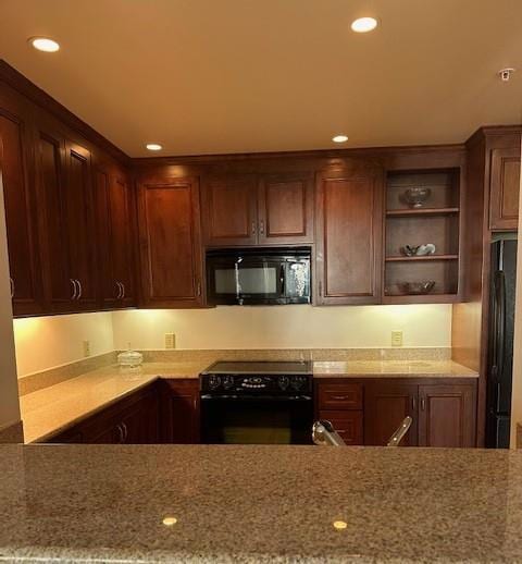 kitchen with black appliances and light stone countertops