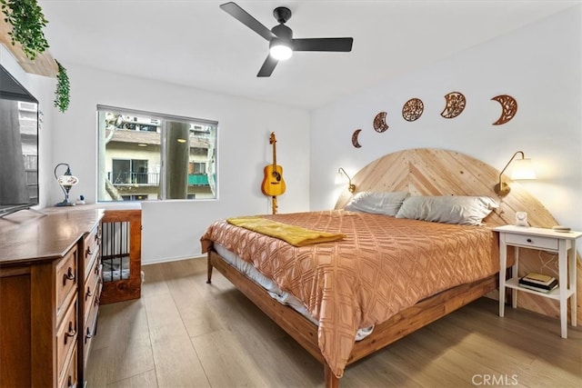 bedroom with ceiling fan and hardwood / wood-style flooring