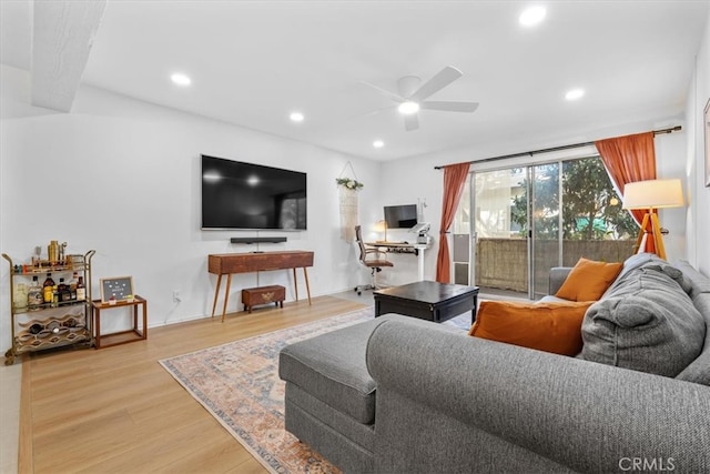 living room featuring ceiling fan and hardwood / wood-style flooring