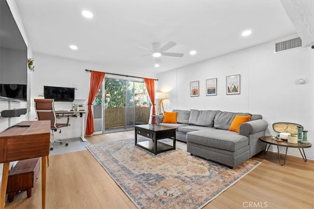 living room featuring ceiling fan and light hardwood / wood-style flooring