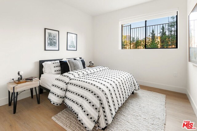 bedroom with light hardwood / wood-style floors