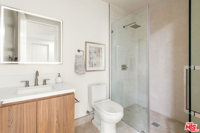 bathroom with toilet, an enclosed shower, and vanity