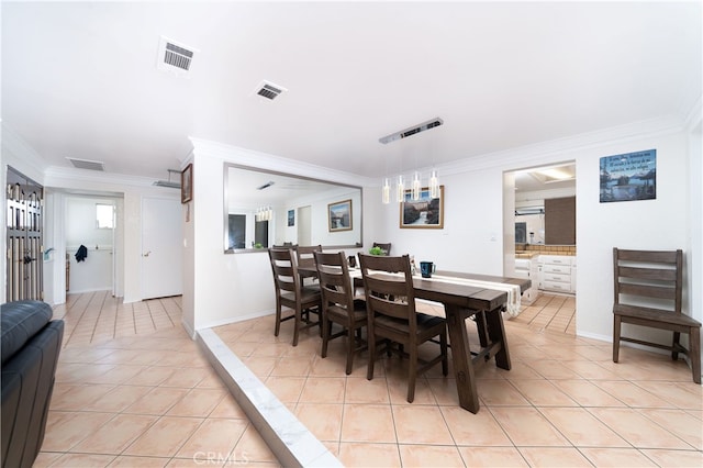 dining area featuring light tile patterned floors and ornamental molding