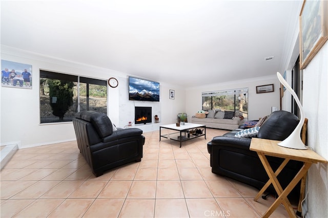 tiled living room featuring ornamental molding and a wealth of natural light