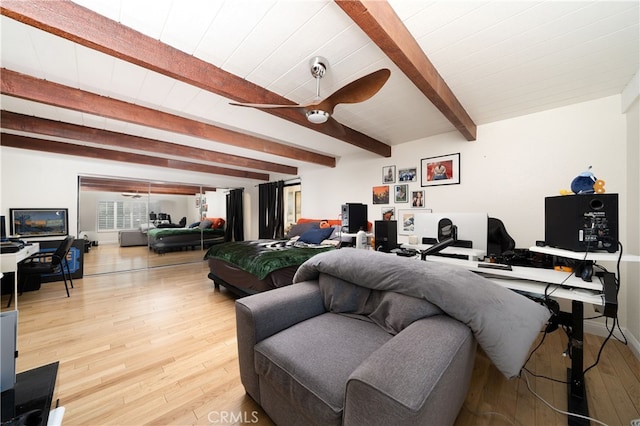 living room with ceiling fan, beamed ceiling, and hardwood / wood-style floors