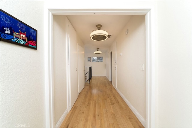 corridor with light wood-type flooring