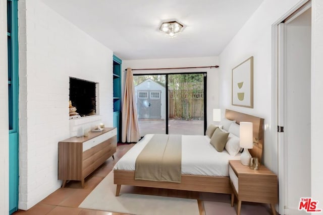 bedroom featuring light tile patterned floors and access to exterior