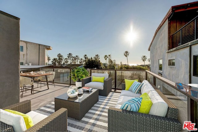 deck at dusk featuring outdoor lounge area