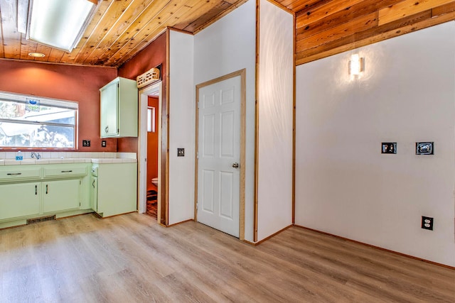 laundry room with light hardwood / wood-style flooring and wooden ceiling