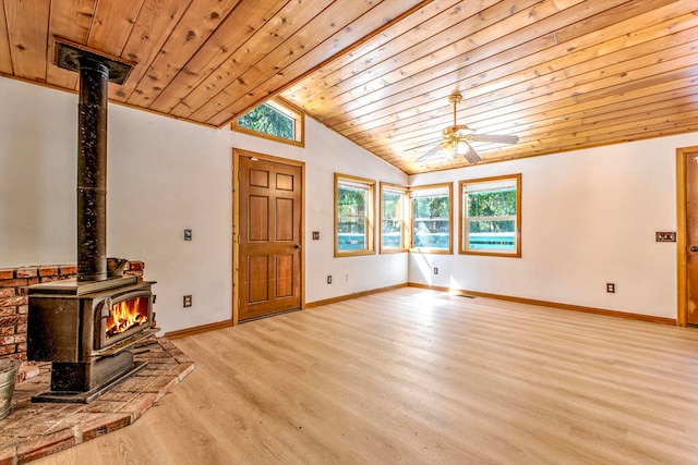 entryway with wood ceiling, a wood stove, lofted ceiling, light hardwood / wood-style flooring, and ceiling fan