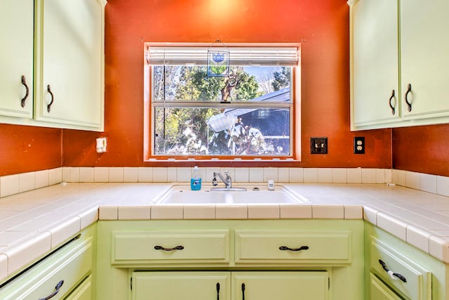 kitchen with tile counters and sink