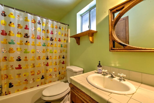 full bathroom featuring shower / bath combo, vanity, and toilet