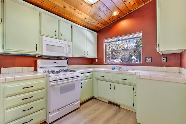 kitchen with wood ceiling, white appliances, tile counters, and lofted ceiling