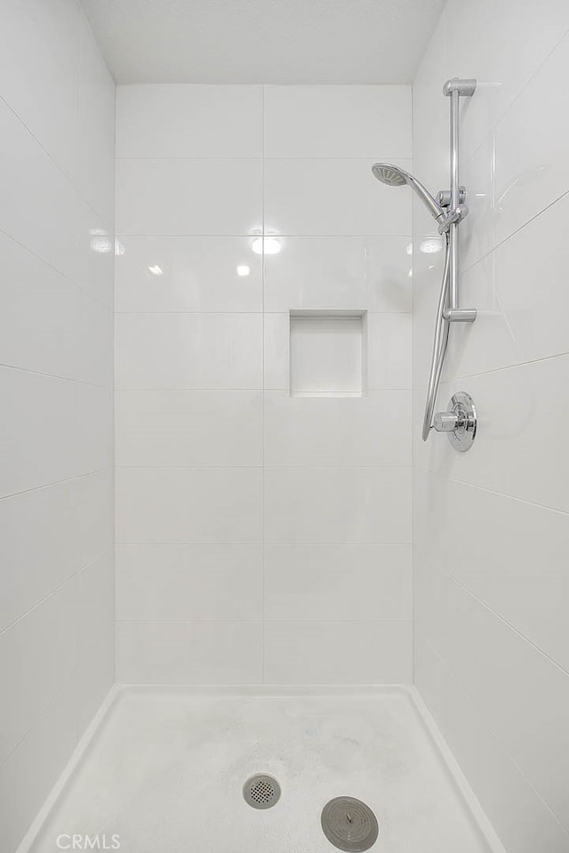 bathroom with a tile shower