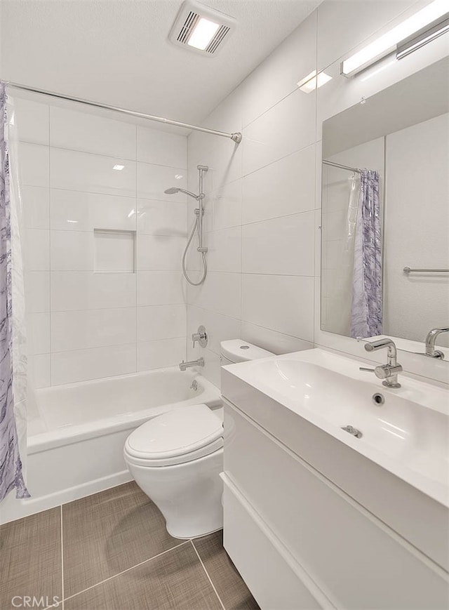 full bathroom with shower / bath combo with shower curtain, tile patterned floors, vanity, and toilet