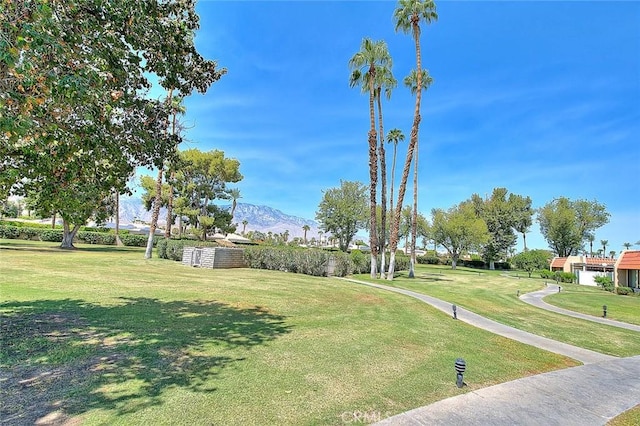 view of home's community with a lawn and a mountain view