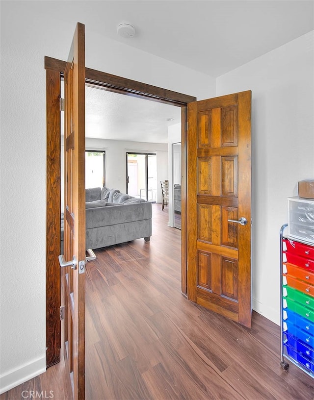 hallway with hardwood / wood-style flooring