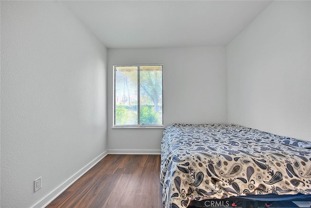 bedroom featuring dark hardwood / wood-style flooring