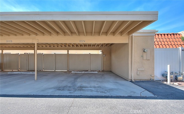 view of parking / parking lot featuring a carport