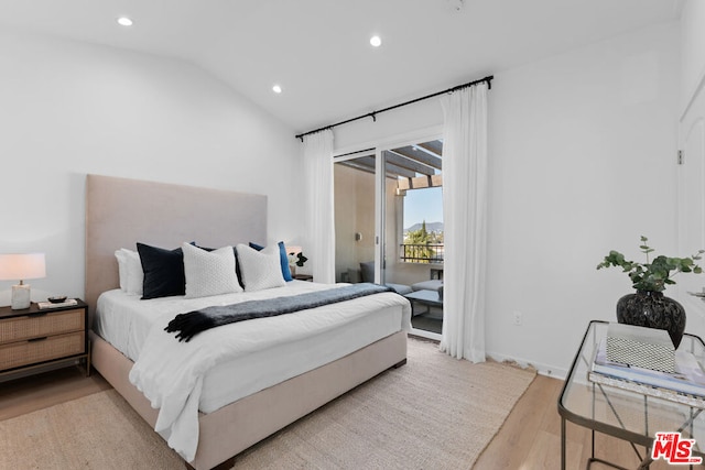 bedroom with vaulted ceiling, light hardwood / wood-style flooring, and access to exterior