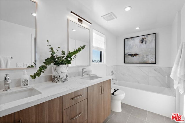 bathroom with vanity, a bathtub, tile patterned flooring, and toilet