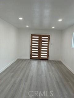 unfurnished room with wood-type flooring