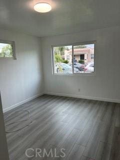 spare room with dark wood-type flooring