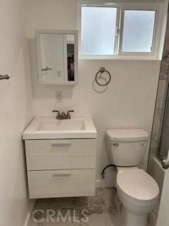 bathroom featuring toilet, vanity, and walk in shower