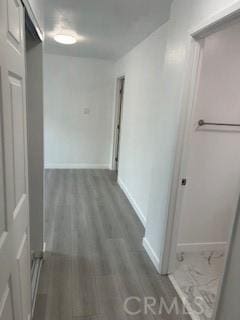 hallway with hardwood / wood-style floors