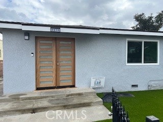 entrance to property featuring a yard