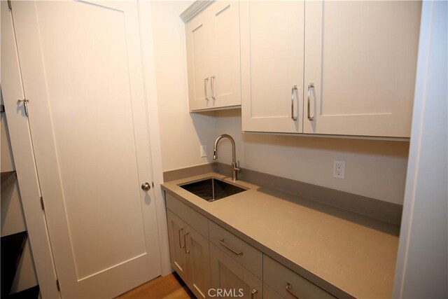 kitchen featuring sink and white cabinets