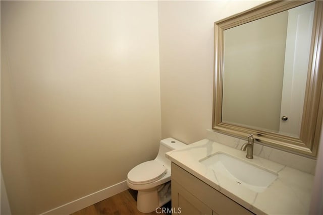 bathroom featuring hardwood / wood-style floors, vanity, and toilet