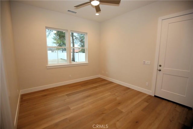 unfurnished room with hardwood / wood-style flooring and ceiling fan