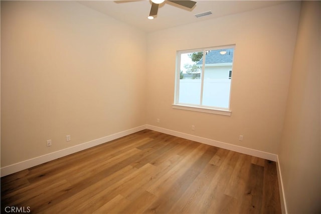 spare room featuring hardwood / wood-style flooring and ceiling fan