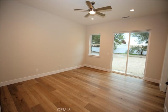 empty room with ceiling fan and light wood-type flooring