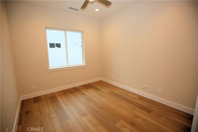 empty room featuring ceiling fan and light hardwood / wood-style floors