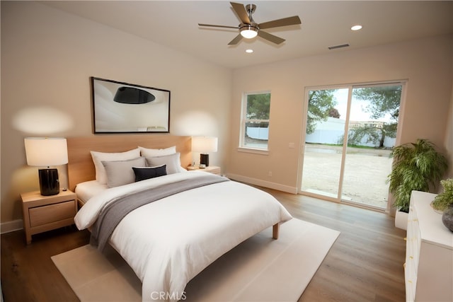 bedroom featuring access to exterior, wood-type flooring, and ceiling fan