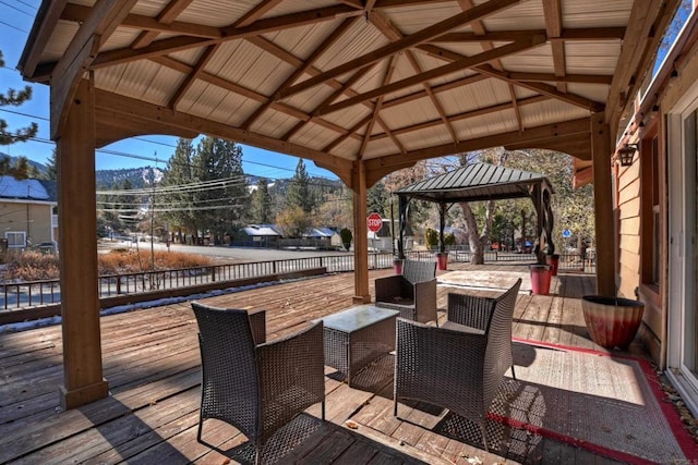 wooden terrace featuring a gazebo