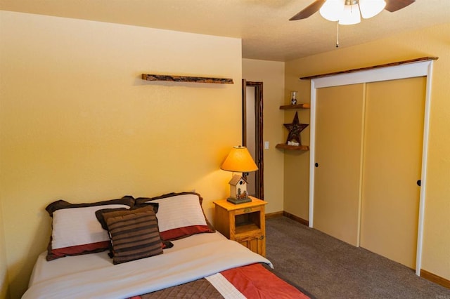 carpeted bedroom with ceiling fan and a closet