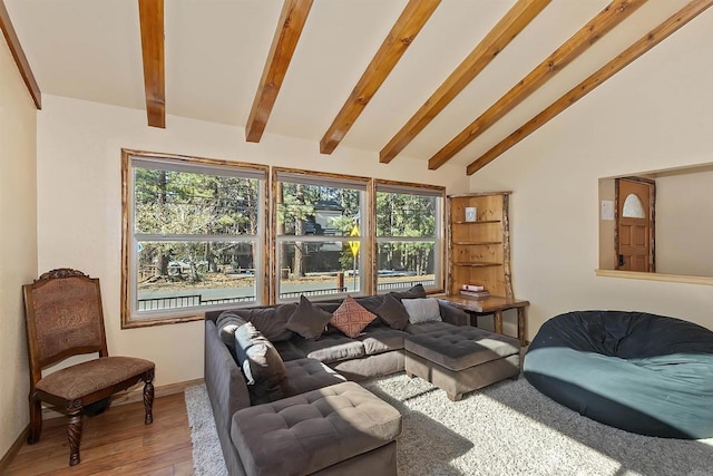 living room with hardwood / wood-style floors and lofted ceiling with beams